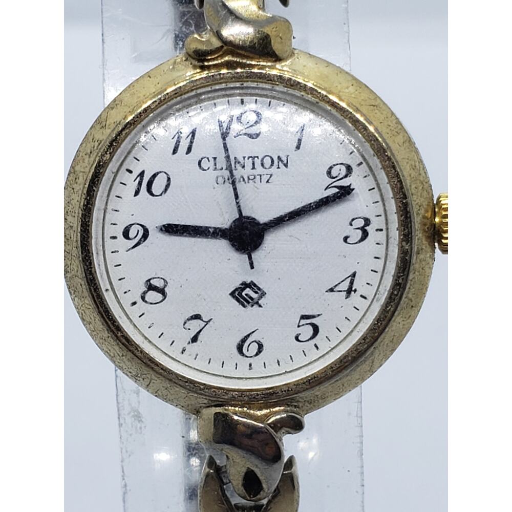 Clinton women's watch. Classic round white face decorative buckles on band